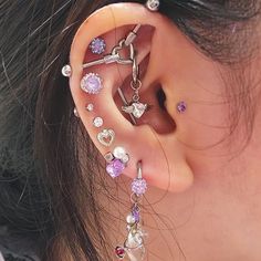 a close up of a person with ear piercings on their ears and behind the ear