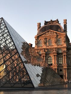 an image of a building with a glass pyramid in the foreground