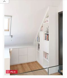 the room is white and has bookshelves in it