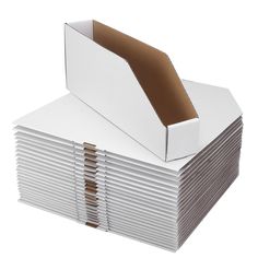 a stack of white boxes on top of each other with brown paper sticking out of them