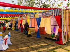 an outdoor event with colorful tents and decorations