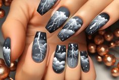 If you’re drawn to more dramatic nail art, the stormy skies design is your go-to. Opt for a dark grey or navy blue base to set the moody tone. Thunderstorm Nail Art, Stormy Nail Designs, Dark Cloud Nails, Storm Nail Art, Smoky Nails Design, Nail Ideas Blue And Black, Tornado Nails, Storm Nails Design, Black Winter Nail Ideas