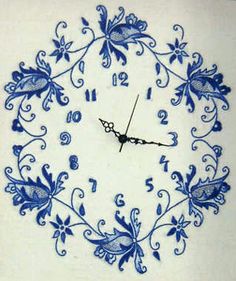 a blue and white clock with floral designs on it