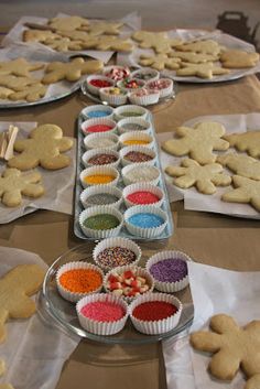 several trays of cookies and cupcakes on a table