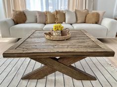 a wooden table sitting in front of a white couch