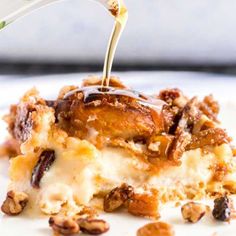 a piece of pecan bread pudding being drizzled with caramel sauce