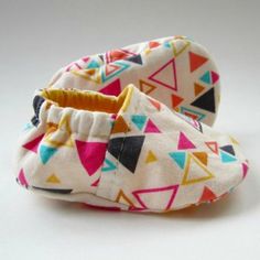 pair of baby shoes with colorful triangles on them