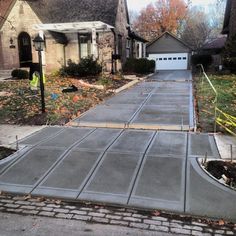 a concrete driveway in front of a house