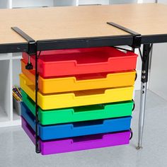 a multicolored plastic drawer on the back of a school desk