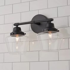 two light fixtures on a white brick wall