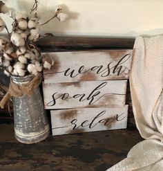 a vase with cotton in it sitting next to a sign that says wash, soak and selte