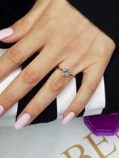 a woman's hand with pink manies and a diamond ring