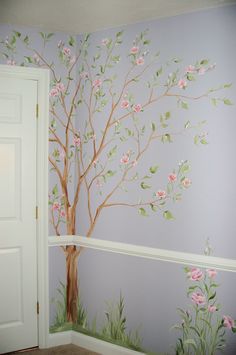 a tree painted on the wall next to a door