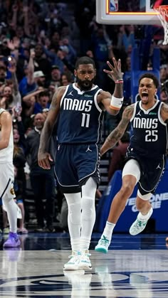 two basketball players are celebrating on the court