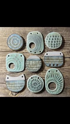 six ceramic dishes with holes in the middle