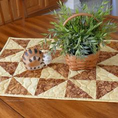 a potted plant sitting on top of a wooden table next to a basket filled with plants