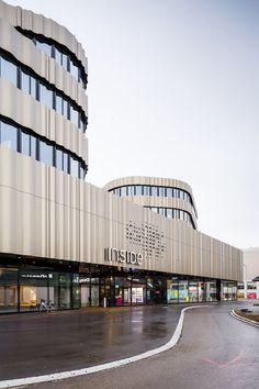 an empty street in front of a large building