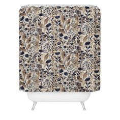 a shower curtain with a floral pattern on the outside and blue, brown, and white colors