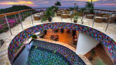 an outdoor swimming pool with colorful tiles on it