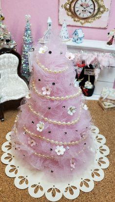 a small pink christmas tree on a table