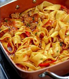 a pan filled with pasta and meat sauce