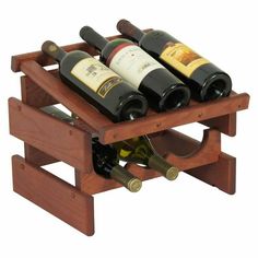 a wooden wine rack with six bottles of wine in it