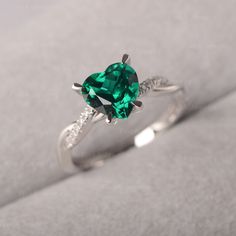 ◆ The ring is handcrafted from sterling silver and decorated with a dazzling 8*8 mm Lab Grown Emerald and CZs. It is suitable for engagement/anniversary/daily occasion. ◆ Production Description: Main stone Type: Lab Grown Emerald Main Stone Shape: Heart Cut Main Stone Size: 8*8 mm(1.59ct) Side stone: CZ Metal: 925 Sterling silver - Other options available in the drop down menu ◆ Customization: √Free for Add Engraving √Other Metal Type Available √Other Gemstones & Shapes Available √Personaliz Silver And Green Rings, Engagement Emerald Rings, Promise Rings Pandora, Birthstone Engagement Rings, Heart Shaped Ring, July Birthstone Ring, Smaragd Ring, Green Sapphire Ring, Emerald Rings