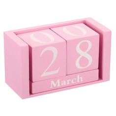 a pink wooden block with the number twenty eight on it's side and the word march written in white