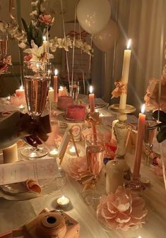 a table is set with candles, flowers and other items for a party or celebration