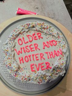 a birthday cake with the words older wise and hotter than ever written on it