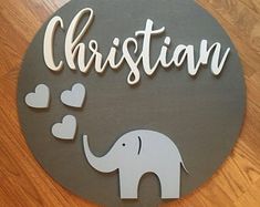 a metal sign that says, christian with an elephant and hearts on it's side