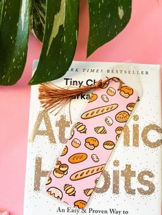 a book with a hot dog on it next to a plant