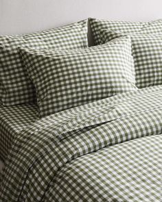 a bed with green and white checkered sheets