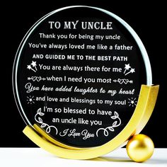 a glass plate with a poem written on it next to a golden ball that says, to my uncle you've always loved me like a father