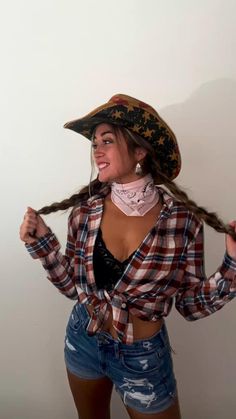 a woman with long hair wearing a pirate hat and bandana is posing for the camera