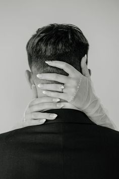 black and white photograph of a man with his hands on his face as if he is holding the woman's head