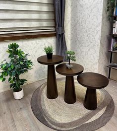 three wooden tables sitting on top of a rug