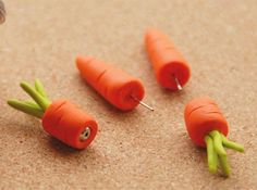 four small carrots with green stems sticking out of them