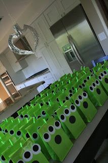 many green bags are lined up on the counter