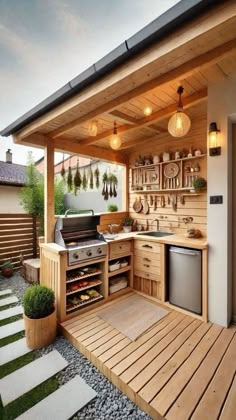 an outdoor kitchen with wood flooring and cabinets