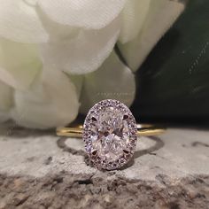 a diamond ring sitting on top of a rock