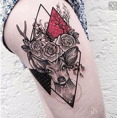 a woman's thigh with a deer and roses tattoo on it