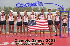 a group of men standing next to each other on top of a swimming pool holding an american flag