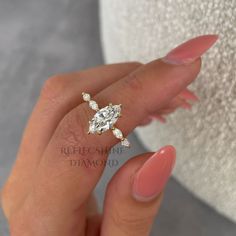 a woman's hand with a diamond ring on it