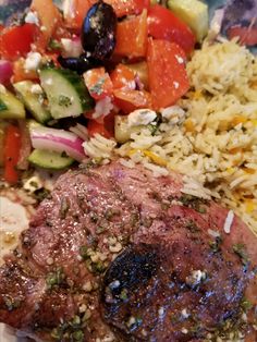 a close up of food on a plate with rice and vegetables in the background,