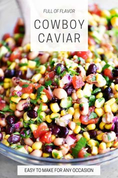 a bowl filled with corn, beans and cilantro on top of a table