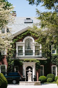 a car parked in front of a large house