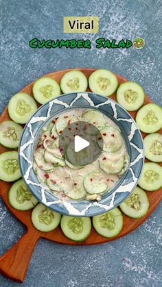 cucumber salad in a blue bowl on a wooden platter with the words virtual