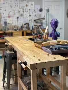 a workbench with various tools on it in a room full of woodwork