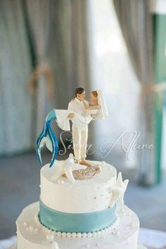 a wedding cake with a bride and groom figurine on top